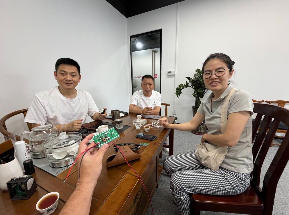 Rey discussing a technology product with business meeting participants